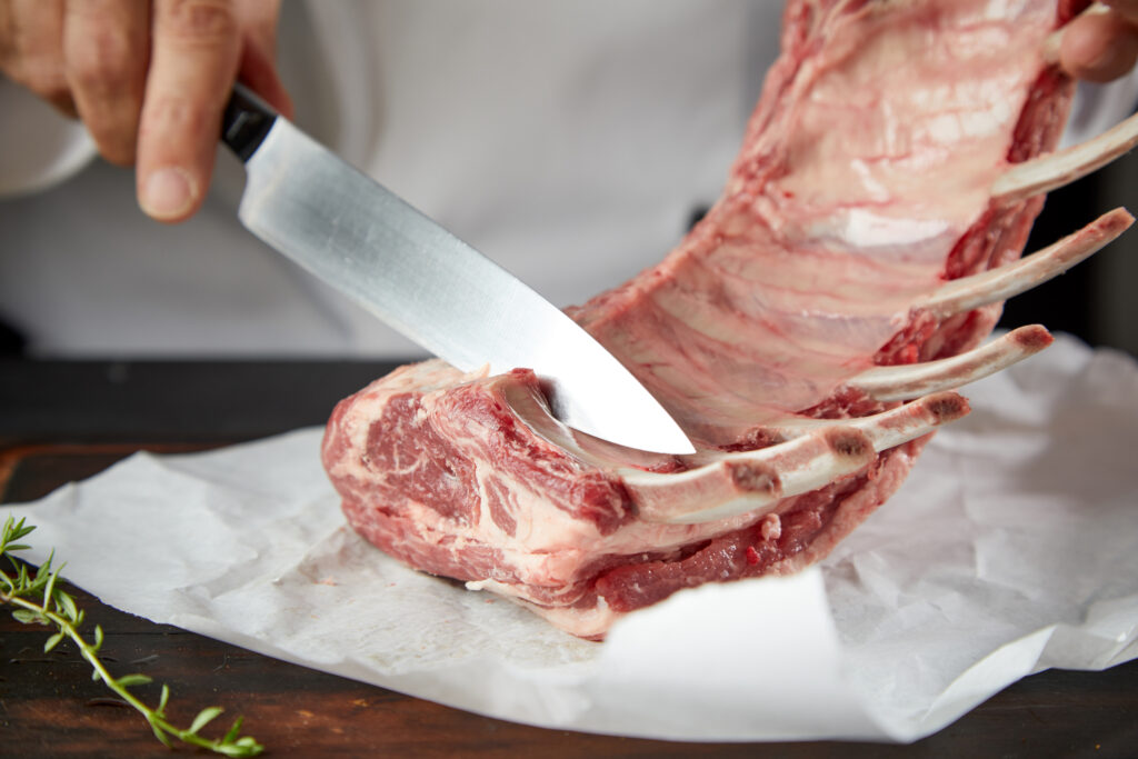 A butcher cutting lamb in a lamb butchery masterclass