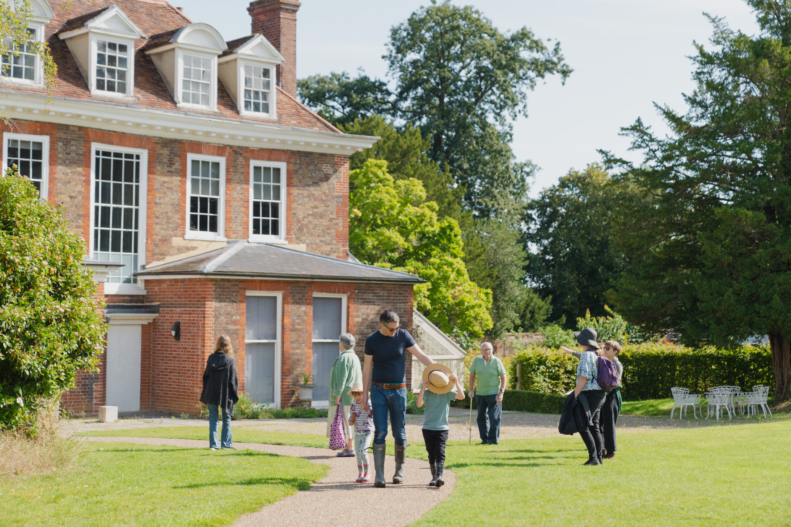 Family on the front lawn of Abbots Hall in the sunshine