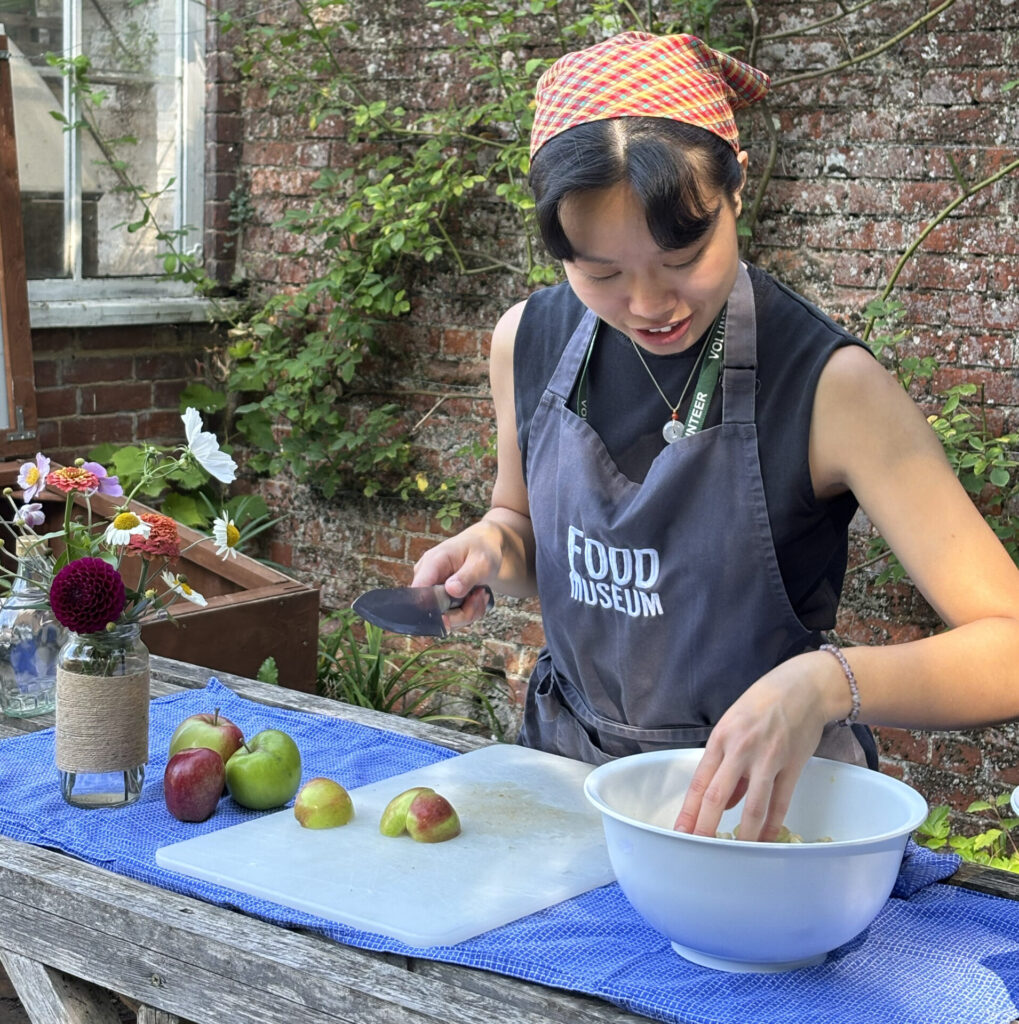 Volunteer valen making apple compote in the walled garden