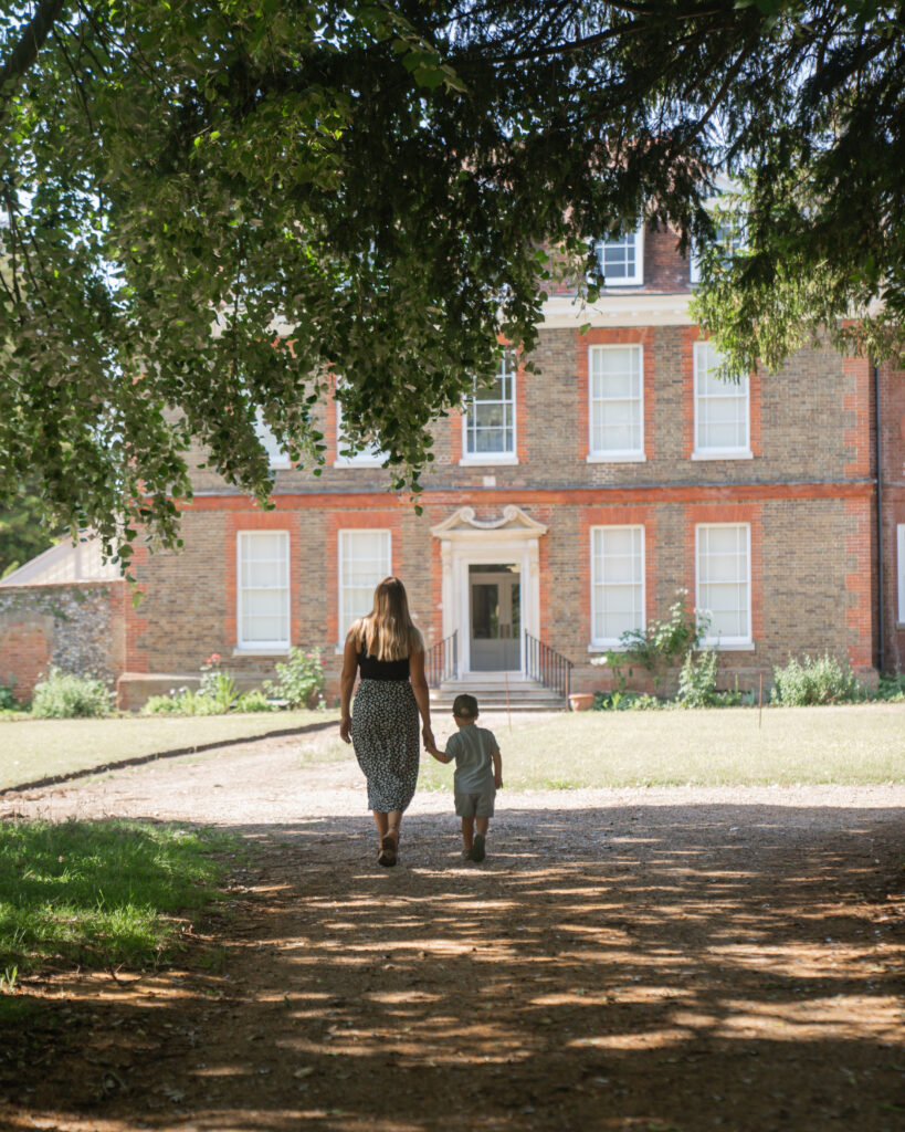 Mother and son walk towards Abbot's Hall